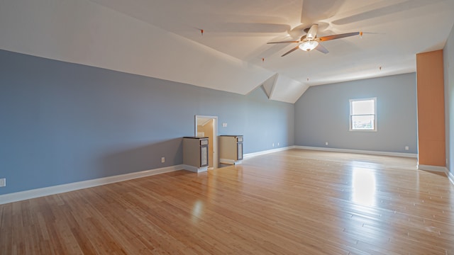 additional living space featuring ceiling fan, light hardwood / wood-style flooring, and vaulted ceiling