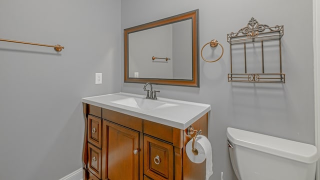 bathroom featuring toilet and vanity