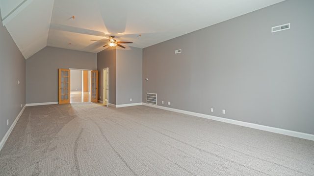 unfurnished room featuring lofted ceiling, light colored carpet, and ceiling fan