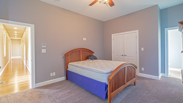 bedroom with ceiling fan, a closet, and carpet