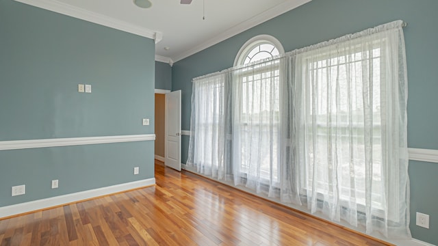 unfurnished room with crown molding, light hardwood / wood-style floors, and ceiling fan