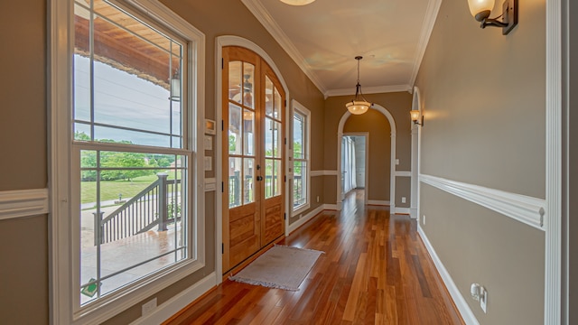 entryway with crown molding, dark hardwood / wood-style floors, and french doors