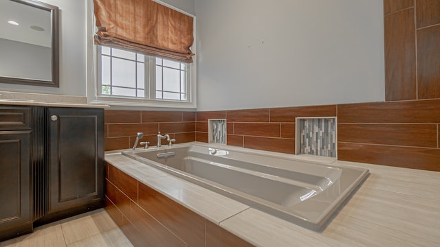 bathroom featuring a relaxing tiled bath and tile floors