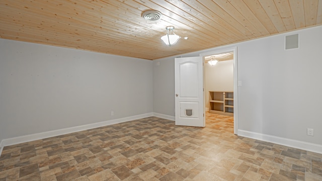 unfurnished room with tile floors and wooden ceiling