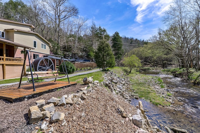 view of yard featuring a deck with water view