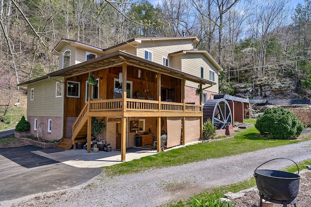 rear view of property featuring a porch