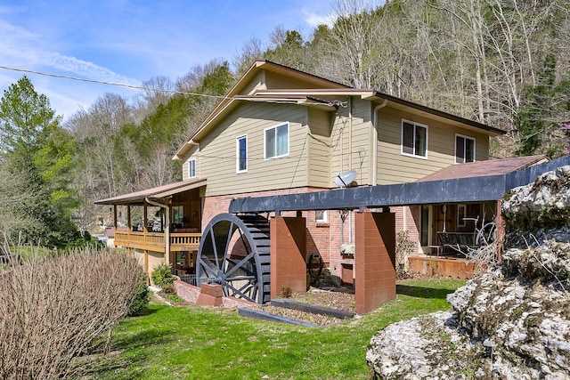 rear view of property featuring a lawn