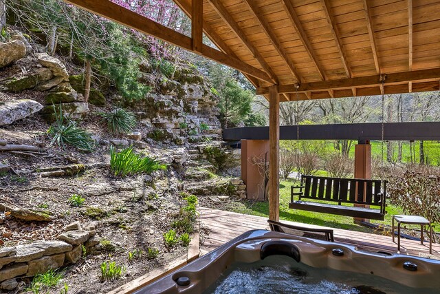 exterior space with an outdoor hot tub