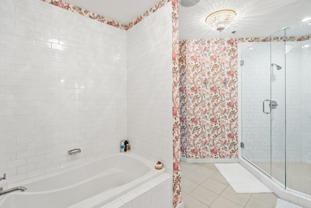 bathroom featuring independent shower and bath and tile flooring