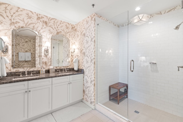 bathroom with walk in shower, oversized vanity, tile floors, and double sink