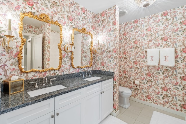 bathroom featuring toilet, tile floors, and double sink vanity