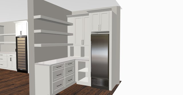 kitchen featuring built in fridge, dark wood-type flooring, and white cabinetry