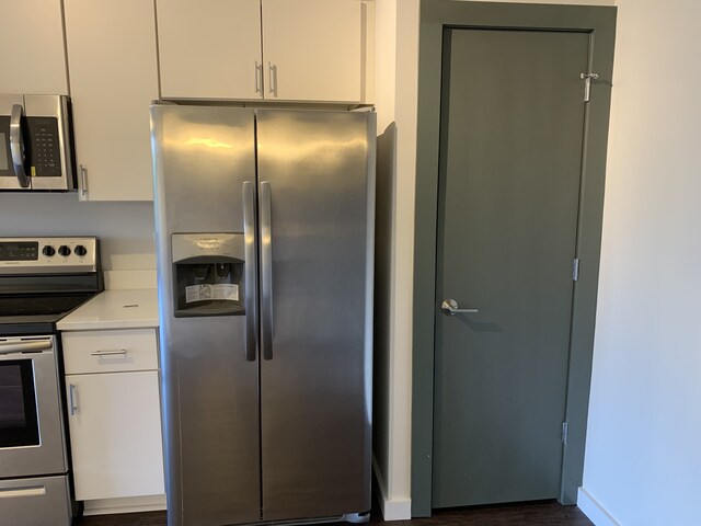 1900 12th Ave S Unit 313, Nashville, TN 37203 - kitchen with stainless steel appliances, dark wood-type flooring, and white cabinetry