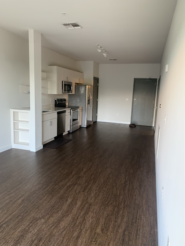 unfurnished living room with dark wood-type flooring