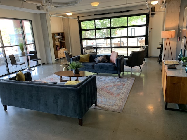 1900 12th Ave S Unit 313, Nashville, TN 37203 - living room featuring concrete flooring and a healthy amount of sunlight