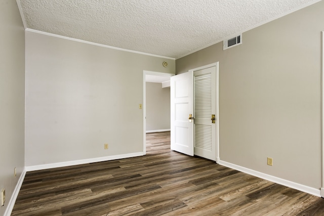 unfurnished bedroom featuring a closet, a textured ceiling, and dark hardwood / wood-style flooring