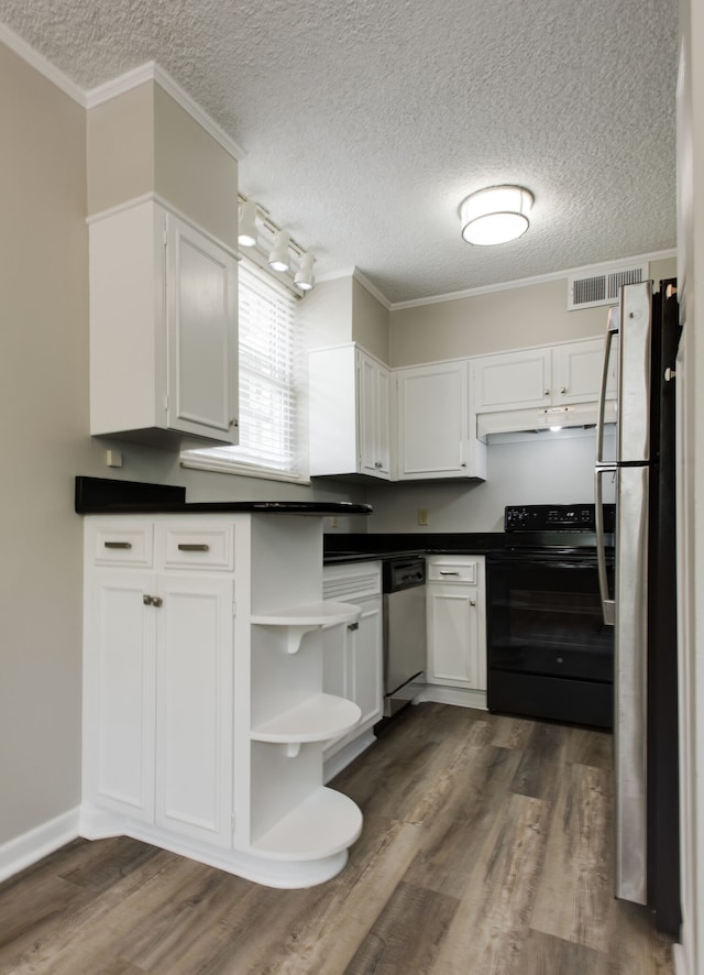 kitchen featuring a textured ceiling, rail lighting, dark wood-type flooring, and stainless steel appliances