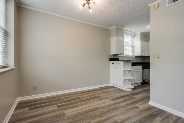 kitchen with a textured ceiling, stainless steel dishwasher, dark hardwood / wood-style floors, and an inviting chandelier