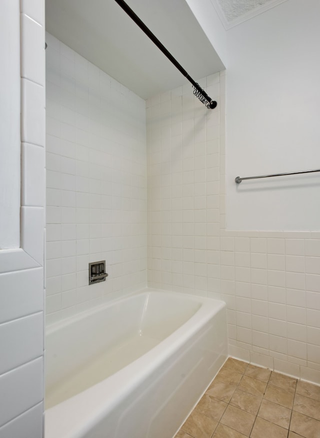 bathroom with tiled shower / bath combo, tile walls, and tile flooring