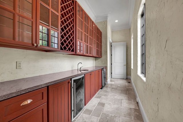 bar featuring sink, ornamental molding, and wine cooler