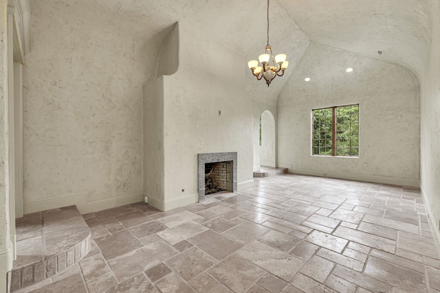 unfurnished living room featuring high vaulted ceiling and a notable chandelier