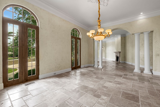 interior space with french doors, crown molding, and a notable chandelier