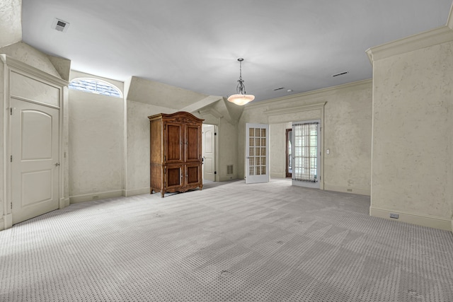 carpeted spare room featuring crown molding