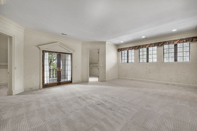 carpeted empty room featuring ornamental molding and french doors