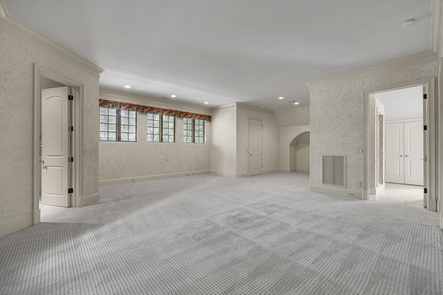 unfurnished living room featuring ornamental molding and light carpet