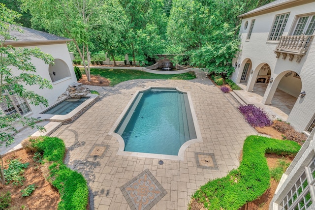 view of swimming pool with a patio area