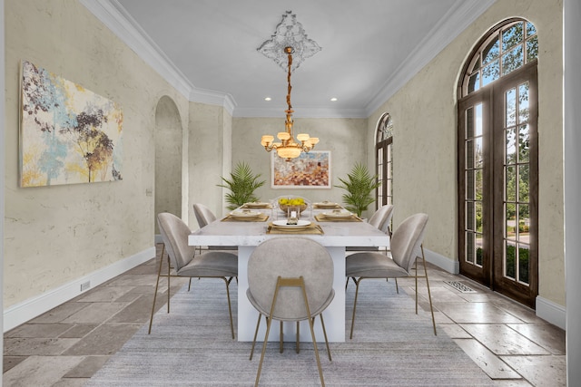 dining room featuring a wealth of natural light, ornamental molding, and french doors