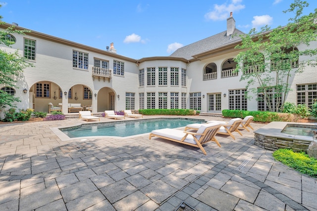 view of swimming pool with a patio area, outdoor lounge area, and an in ground hot tub