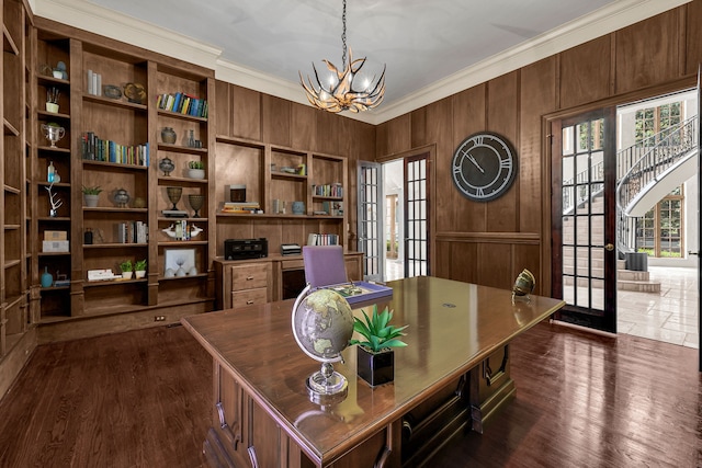 office area with wooden walls, dark hardwood / wood-style floors, french doors, a chandelier, and crown molding