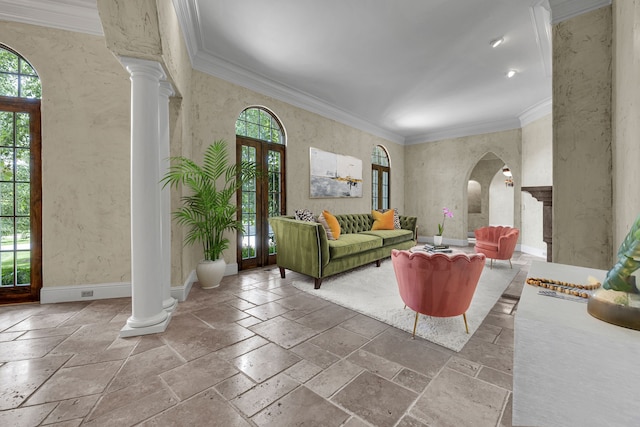 living room with french doors, crown molding, and ornate columns