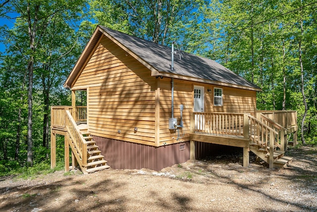 back of property with a wooden deck