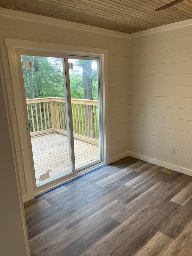 unfurnished room featuring dark hardwood / wood-style floors and wooden ceiling