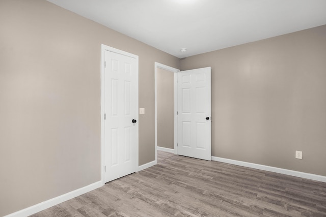 empty room with light hardwood / wood-style floors