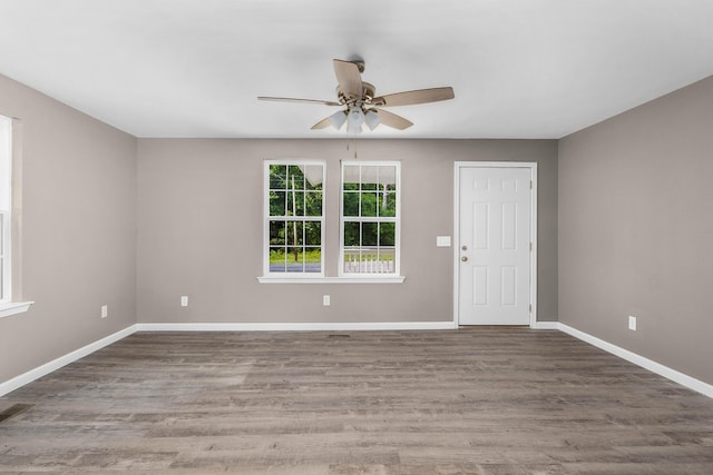 empty room featuring ceiling fan and dark wood-type flooring