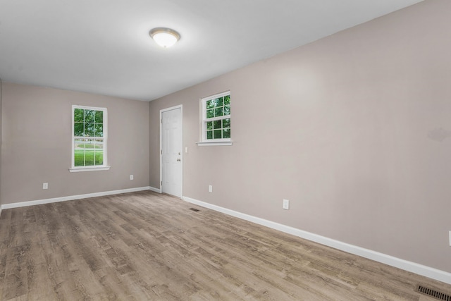 empty room with light hardwood / wood-style flooring