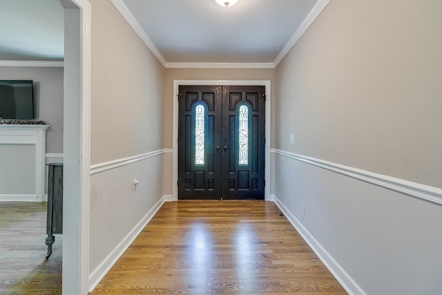 entrance foyer with crown molding and light hardwood / wood-style flooring