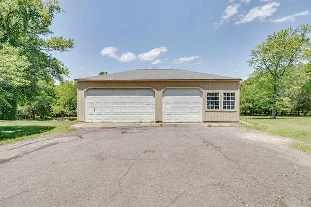 garage featuring a lawn