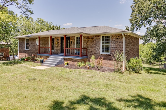 single story home with covered porch and a front yard