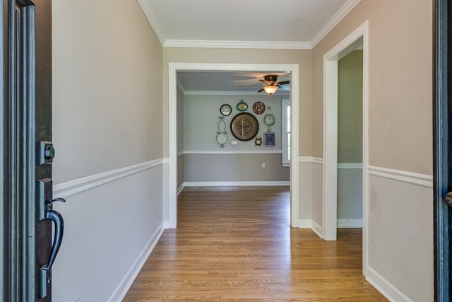 interior space with light hardwood / wood-style floors and crown molding