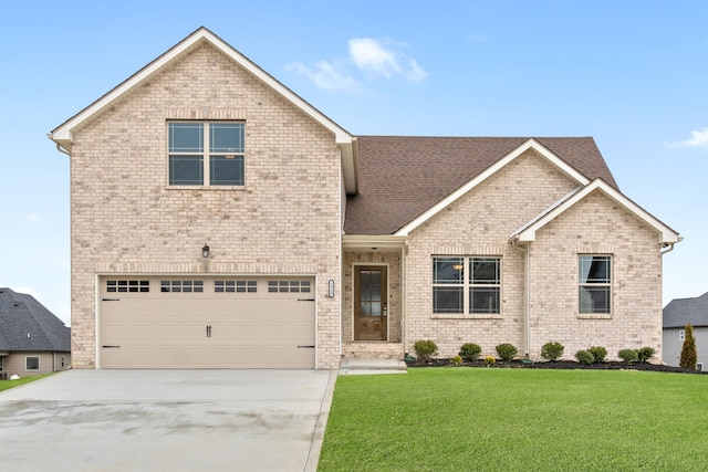 view of property featuring a front lawn and a garage