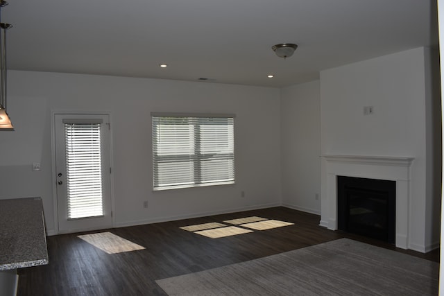 unfurnished living room with dark hardwood / wood-style floors