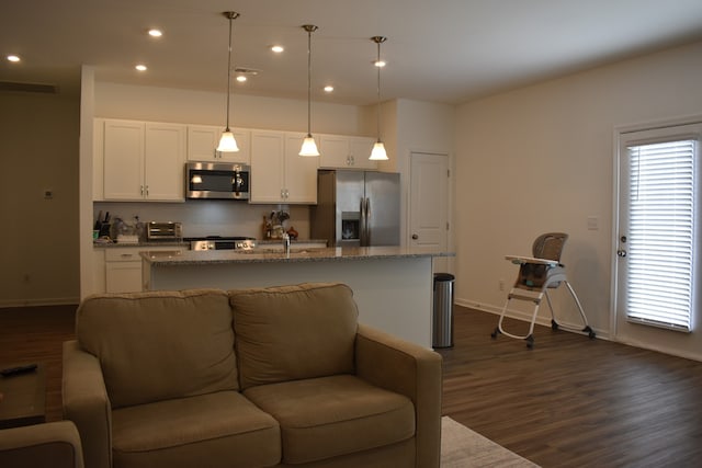 living room featuring sink and dark wood-type flooring