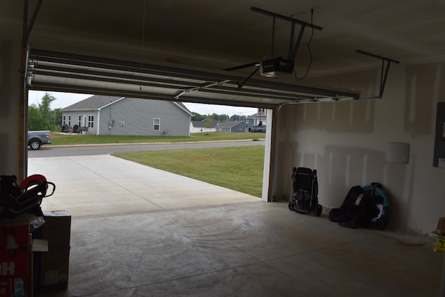 garage with a yard and a garage door opener