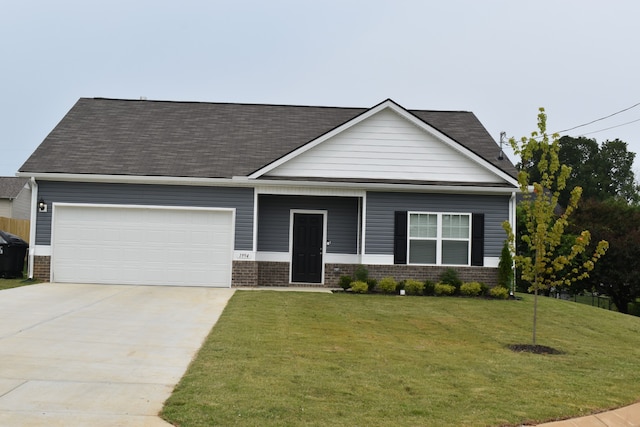 view of front of home featuring a front yard and a garage