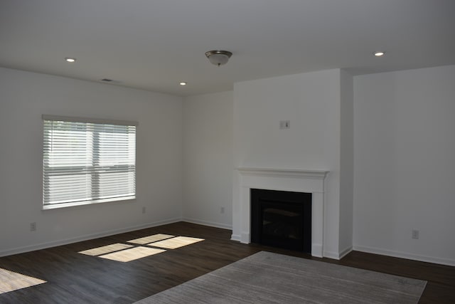 unfurnished living room with dark hardwood / wood-style floors