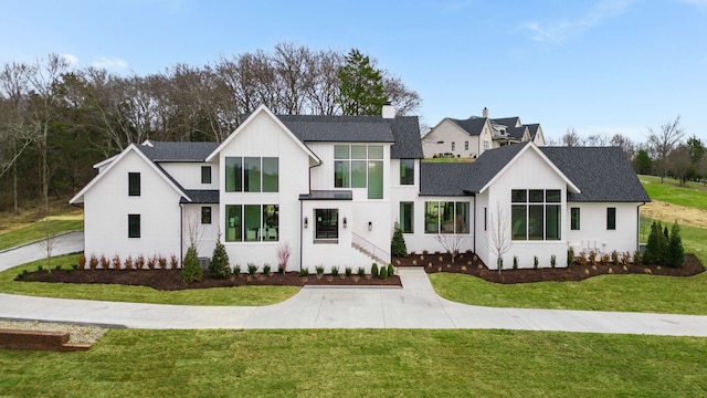 modern farmhouse with a front lawn